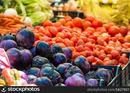 Fresh vegetables on the market. Red cabbage and tomato.