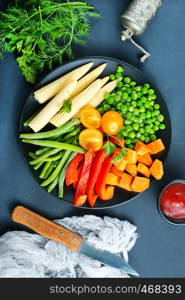 fresh vegetables, raw vegetables on black plate