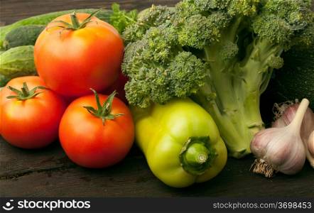 Fresh vegetables: tomatoes, cucumbers, broccoli, zucchini and garlic
