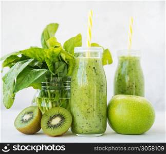 Fresh vegetarian smoothie drink in a glass bottle of green fruits and vegetables.