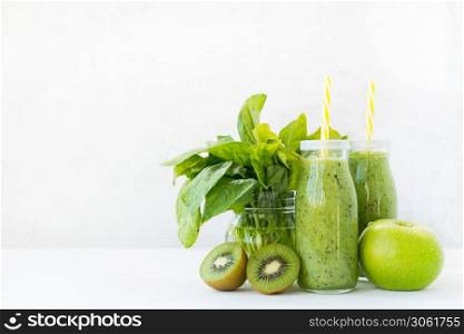 Fresh vegetarian smoothie drink in a glass bottle of green fruits and vegetables.
