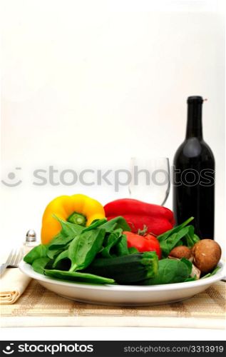 Fresh Veggies. Assorted vegetables including spinach, red and yellow bell pepper, squash and mushrooms served on a single place setting
