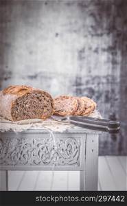 fresh walnut bread on a table with knife