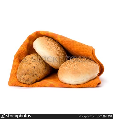 Fresh warm bread over kitchen towel isolated on white background