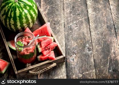 Fresh watermelon juice. On a wooden background.. Fresh watermelon juice.