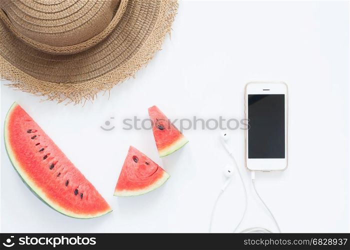 Fresh watermelon with smartphone and hat, Summer concept flat lay on white background