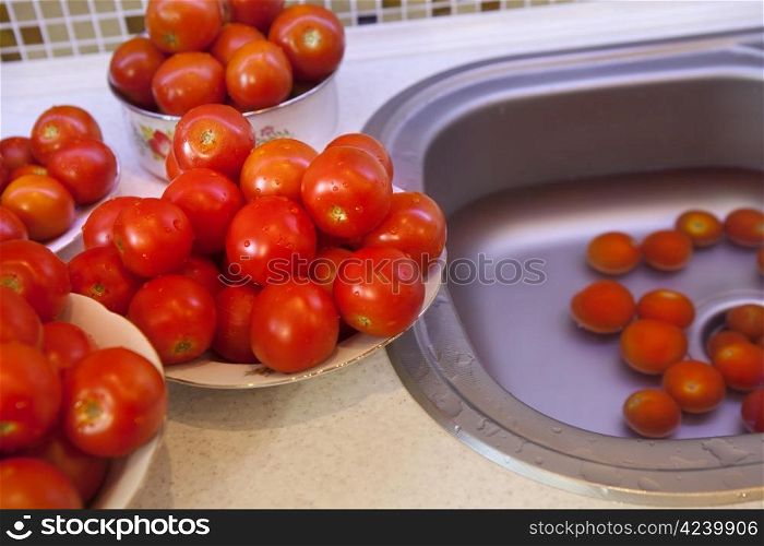 Fresh wet tomatoes on a plate prepared for pasteurization