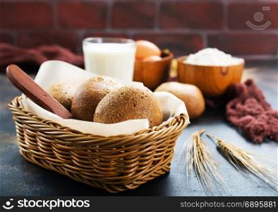 fresh wheat bread in basket and on a table