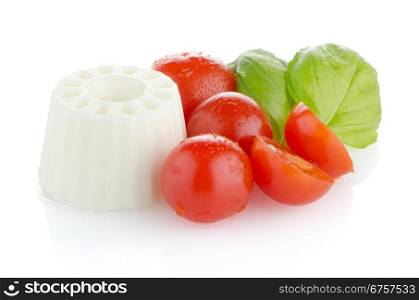 Fresh white cheese, cherry tomatoes and parsley leaves on white reflective background.