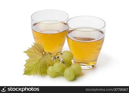 Fresh white grape juice in glasses on white background