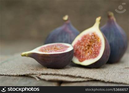 Fresh whole figs on wooden and hessian background