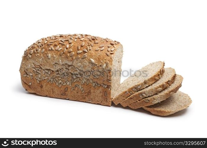 Fresh wholewheat bread with sunflower seeds and slices on white background