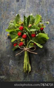 fresh Wild strawberries on wooden background - summer, healthy or vegetarian eating concept