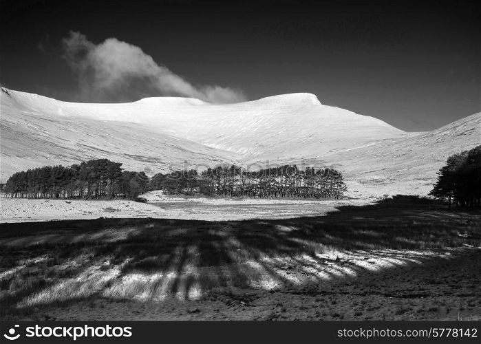 Fresh Winter landscape of mountain range covered in snow black and white