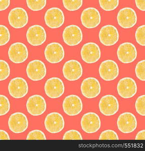 Fresh yellow lemon slices seamless pattern. Close up of citrus fruit slices on bright coral background. Studio photography.. Background of fresh yellow lemon slices. Seamless pattern. Close up. Studio photography.