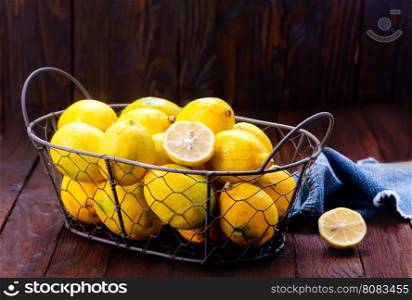 fresh yellow lemons on the wooden table