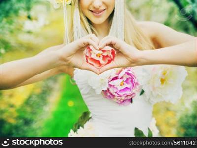 Fresh young woman making the heart sign