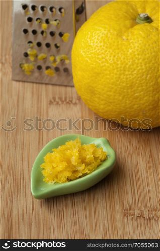 Fresh zest of a yellow Japanese Yuzu and grater