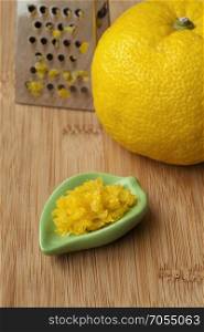 Fresh zest of a yellow Japanese Yuzu and grater