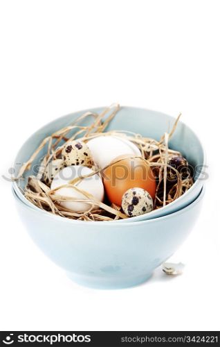 Freshl eggs in blue bowl over white