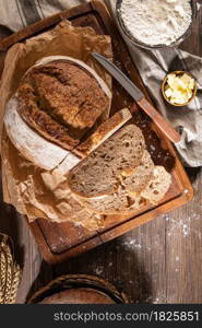 Freshly artisan baked wheat and rye bread, country bread. Simple bread with butter for breackfast