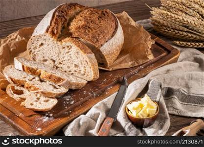 Freshly artisan baked wheat and rye bread, country bread. Simple bread with butter for breackfast