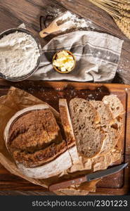 Freshly artisan baked wheat and rye bread, country bread. Simple bread with butter for breackfast