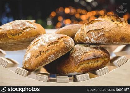 freshly baked bread and baked goods on the shelves on the counter of the bakery.