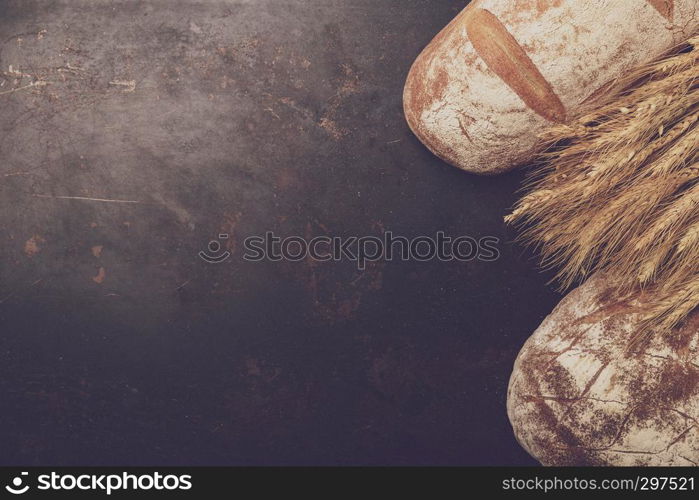 Freshly baked bread and flour in a bakery concept set dark moody