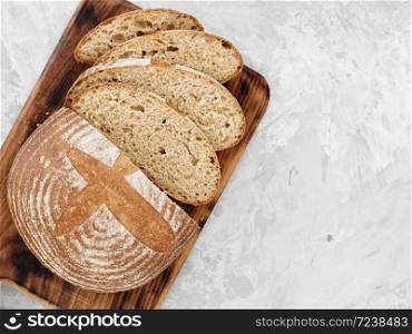 Freshly baked bread on the table. Space for text. The bread is sliced. Top view.
