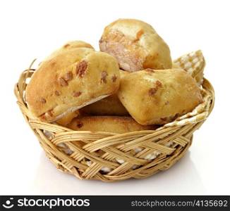 Freshly baked bread rolls in a basket on white background