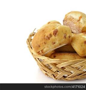 Freshly baked bread rolls in a basket on white background