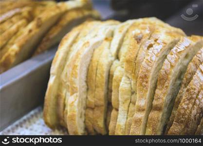freshly baked bread sliced on the conveyor belt