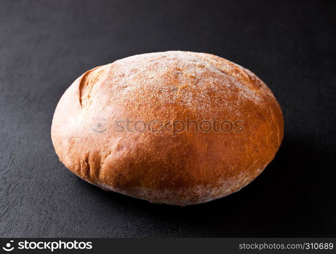 Freshly baked gluten free organic bread on black background