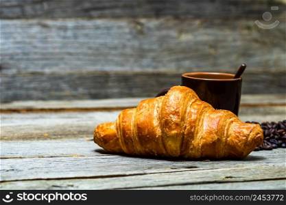 Freshly baked golden brown French croissants. Tasty baked croissants, warm buttery croissants with coffee, breakfast concept