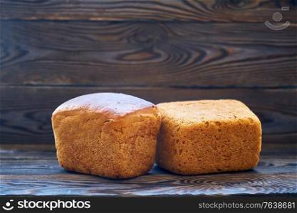 Freshly baked homemade bread on dark wooden table