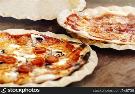 Freshly baked margherita pizza topped with tomato sauce, mozzarella and mushrooms. Typical recipe of Italian cuisine