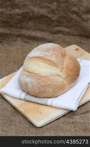 Freshly baked pain de campagne loaf bread in rustic setting