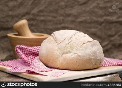 Freshly baked pain de campagne loaf bread in rustic setting