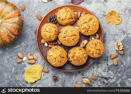 Freshly baked pumpkin muffins with nut.Autumn dessert.Cupcake on plate. Homemade delicious pumpkin muffin