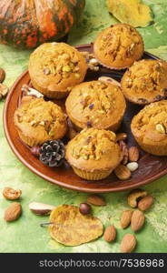 Freshly baked pumpkin muffins with nut.Autumn dessert.Cupcake on plate. Homemade pumpkin muffins