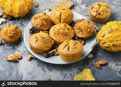 Freshly baked pumpkin muffins with nut.Autumn dessert.Cupcake on plate. Homemade pumpkin muffins