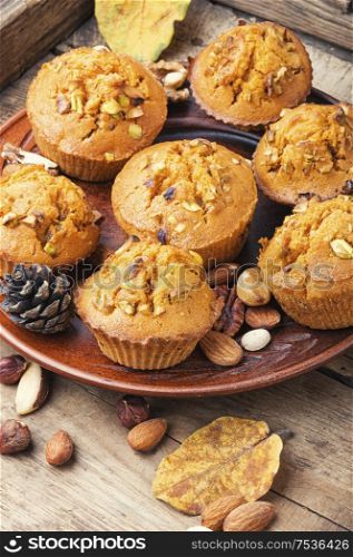 Freshly baked pumpkin muffins with nut.Autumn dessert.Fall baking. Homemade delicious pumpkin muffin
