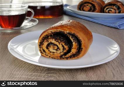 Freshly baked rolls with poppy seeds on a plate