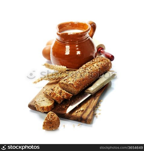 Freshly baked traditional bread and milk on white background