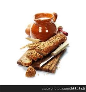 Freshly baked traditional bread and milk on white background