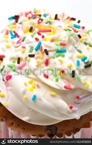 freshly baked vanilla cupcakes with lemon buttercream and sprinkles