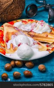 freshly baked waffle pecan coconut dessert with appendices ice cream .Shallow DOF. freshly baked waffle pecan coconut dessert
