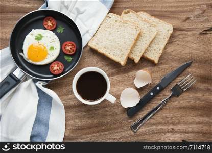 Freshly breakfast setting with black coffee and omelette on the table wooden overhead shot with copyspace