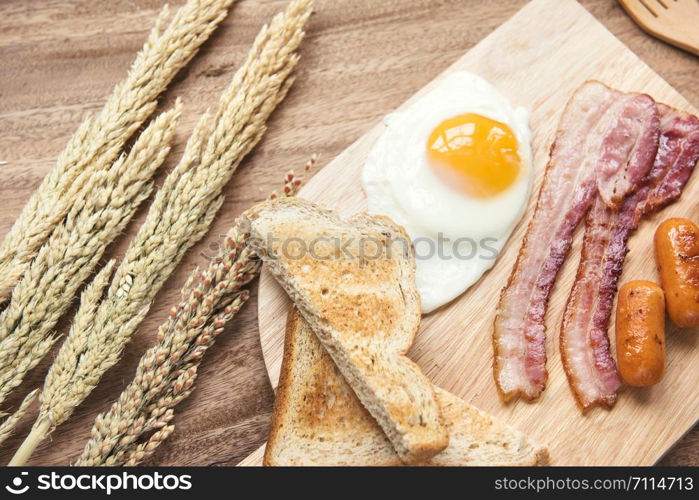Freshly breakfast setting with black coffee and sauaage bacon omelette on the table wooden overhead shot with copyspace